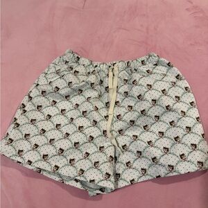 white shorts with cats and blue details on them.